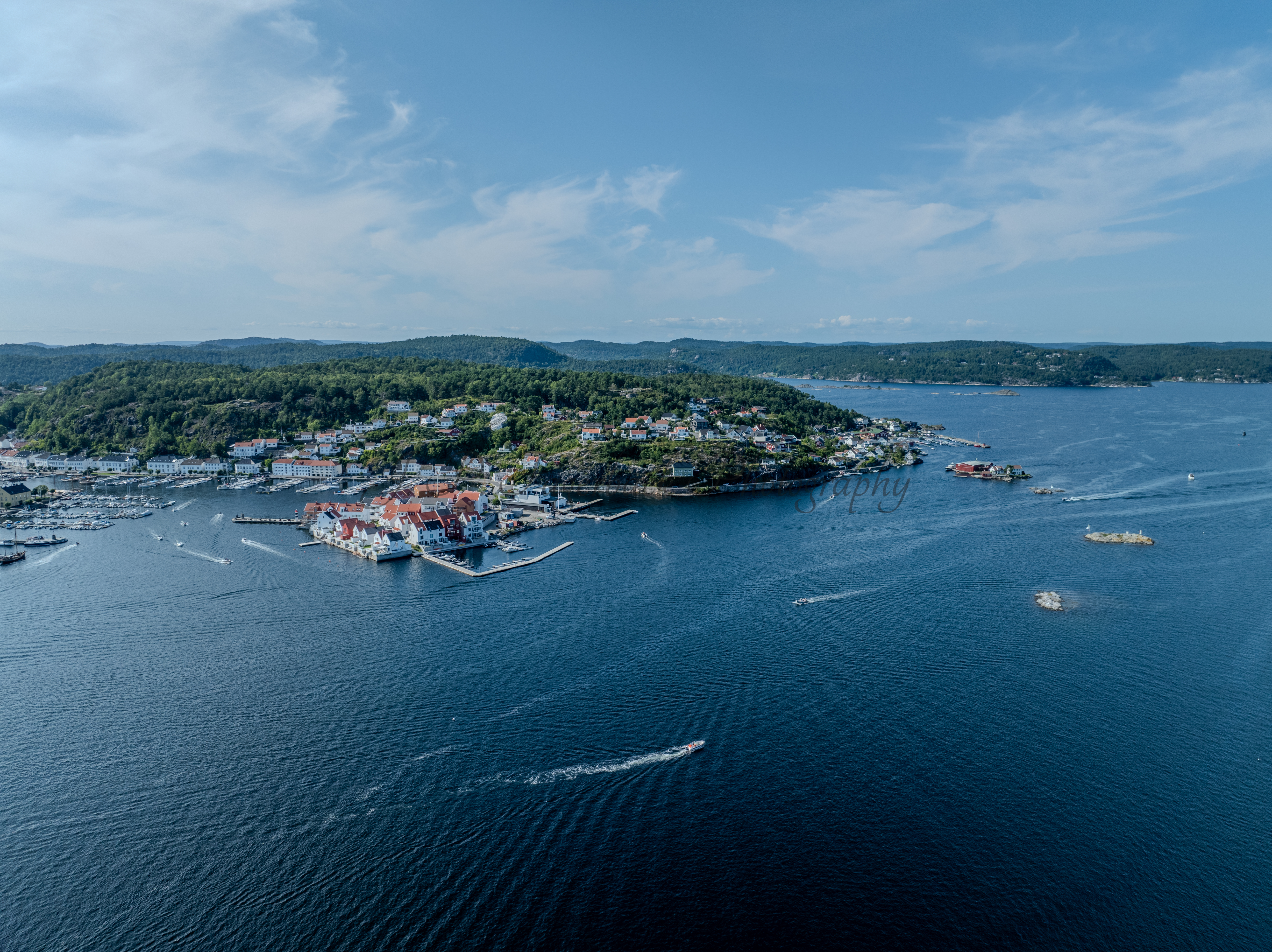 A town with small white houses along a shoreline