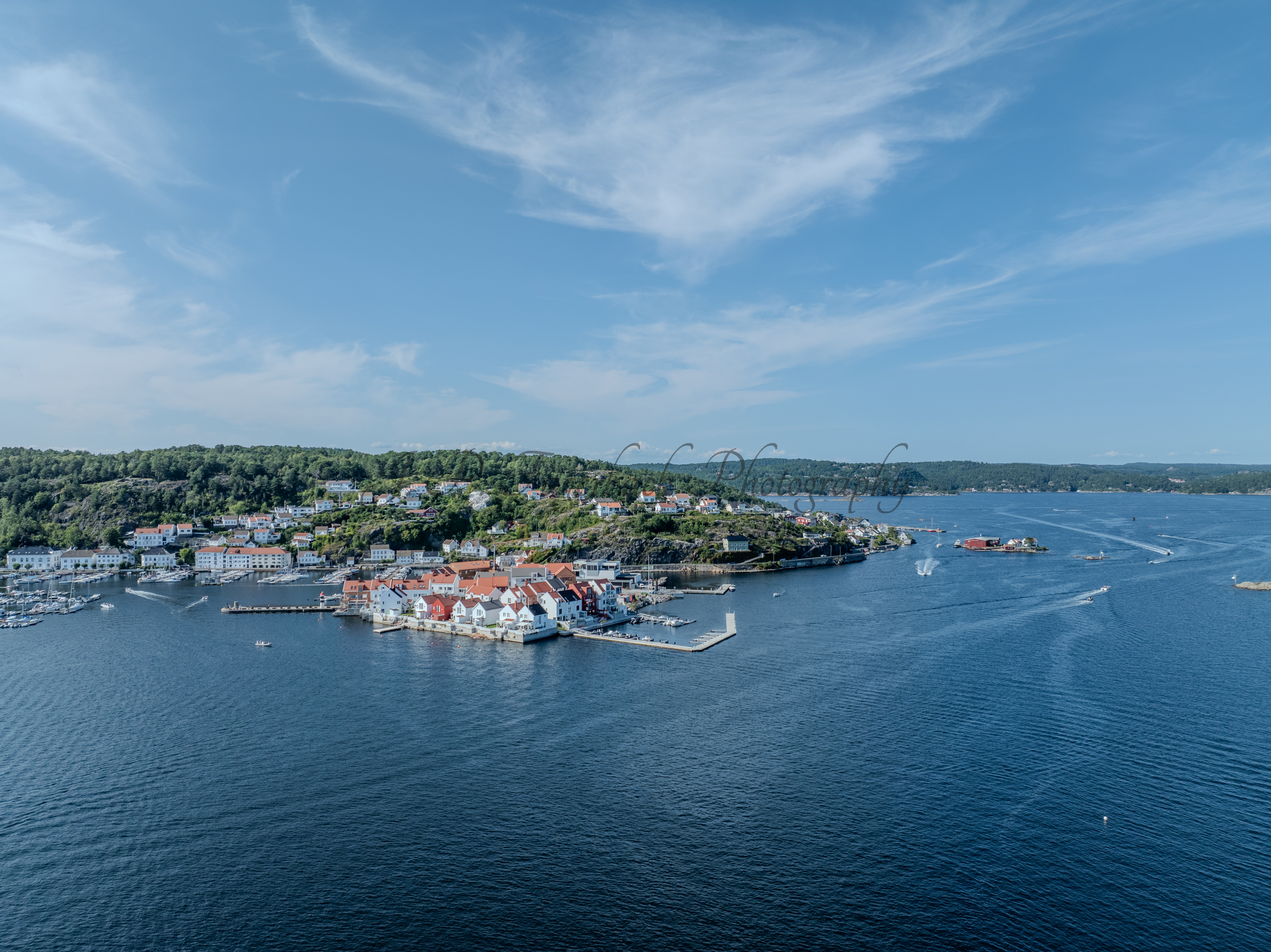 A town with small white houses along a shoreline