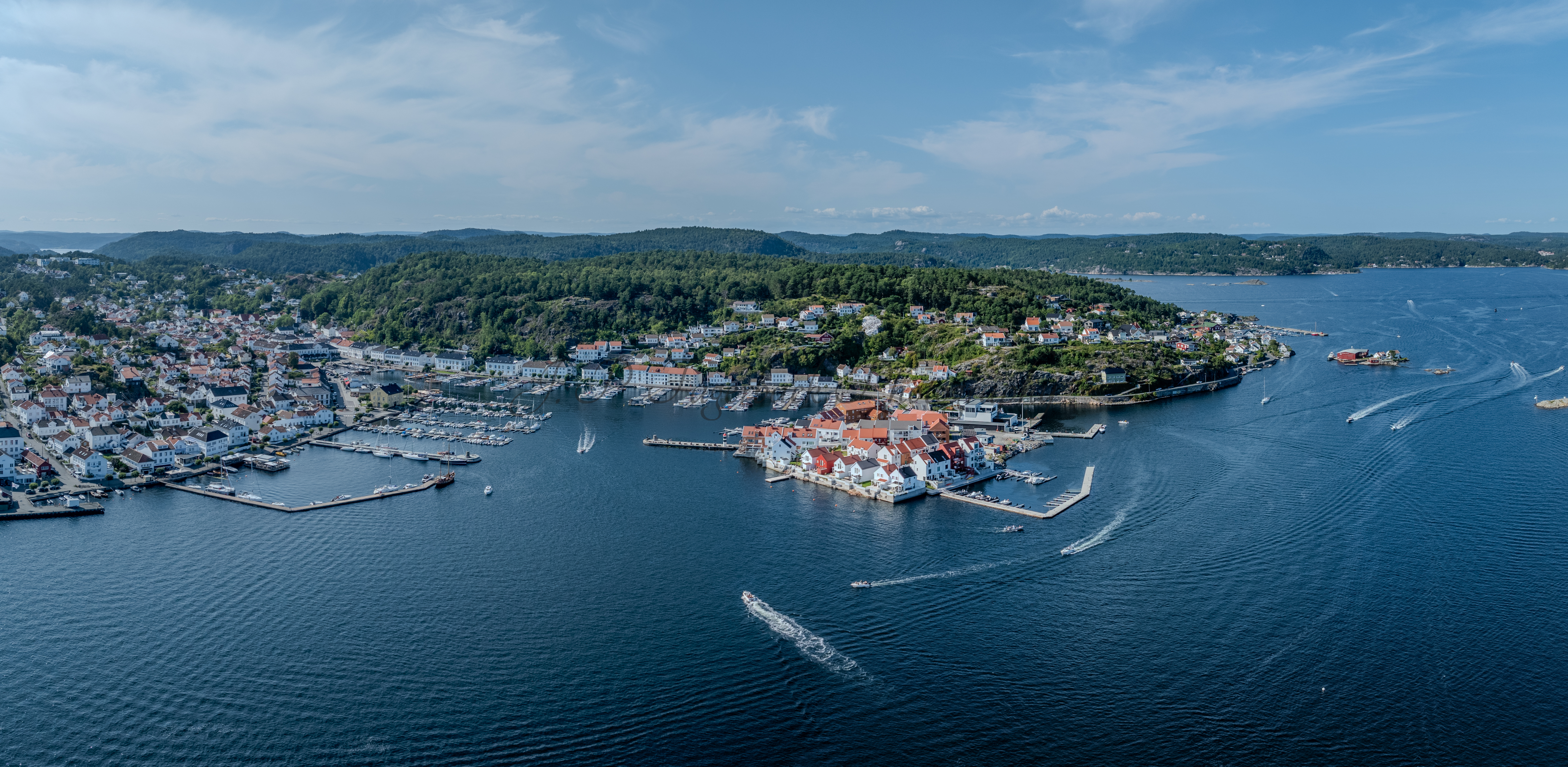 A panorama view of a town with small white houses along a shoreline