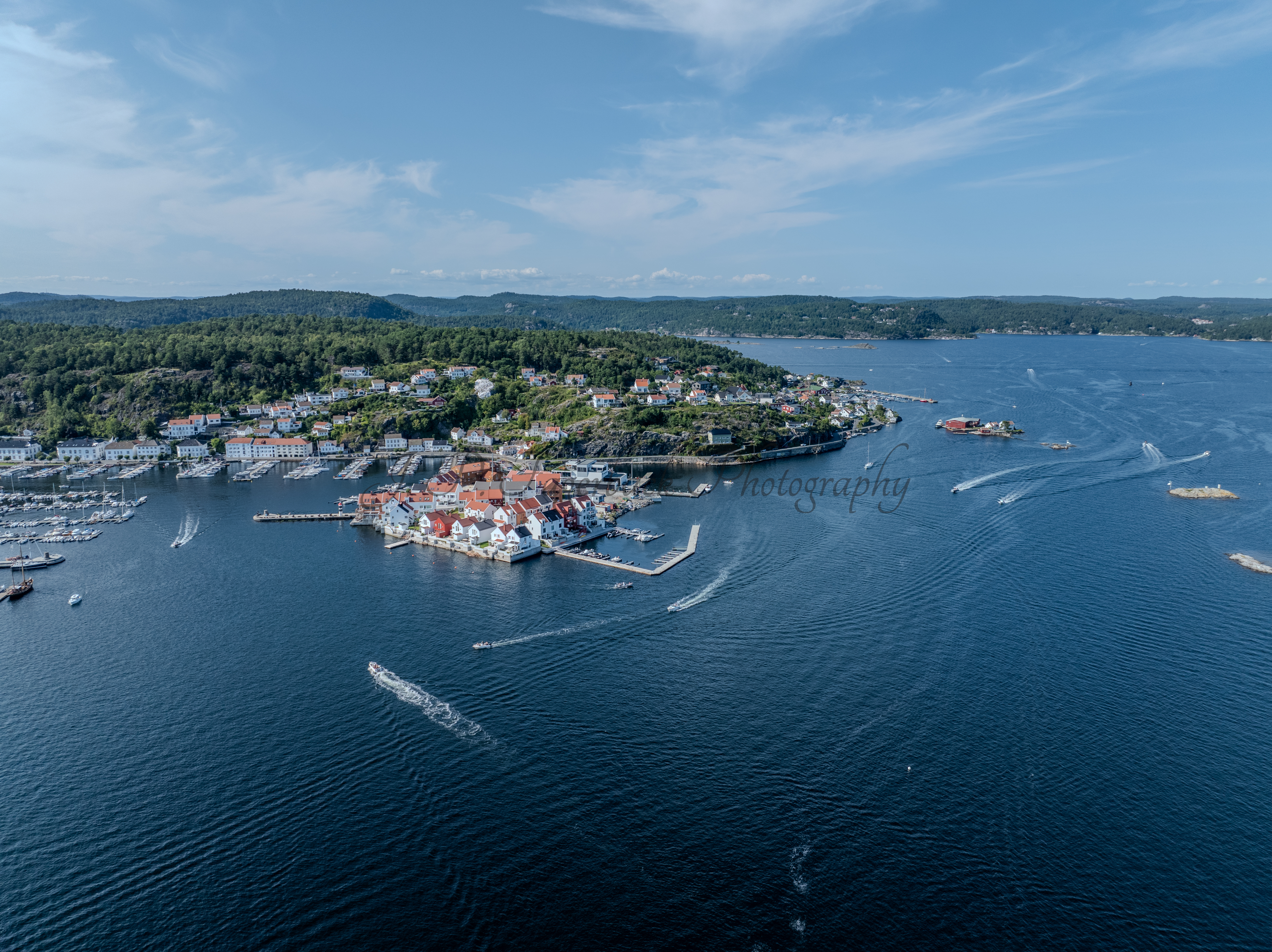A town with small white houses along a shoreline