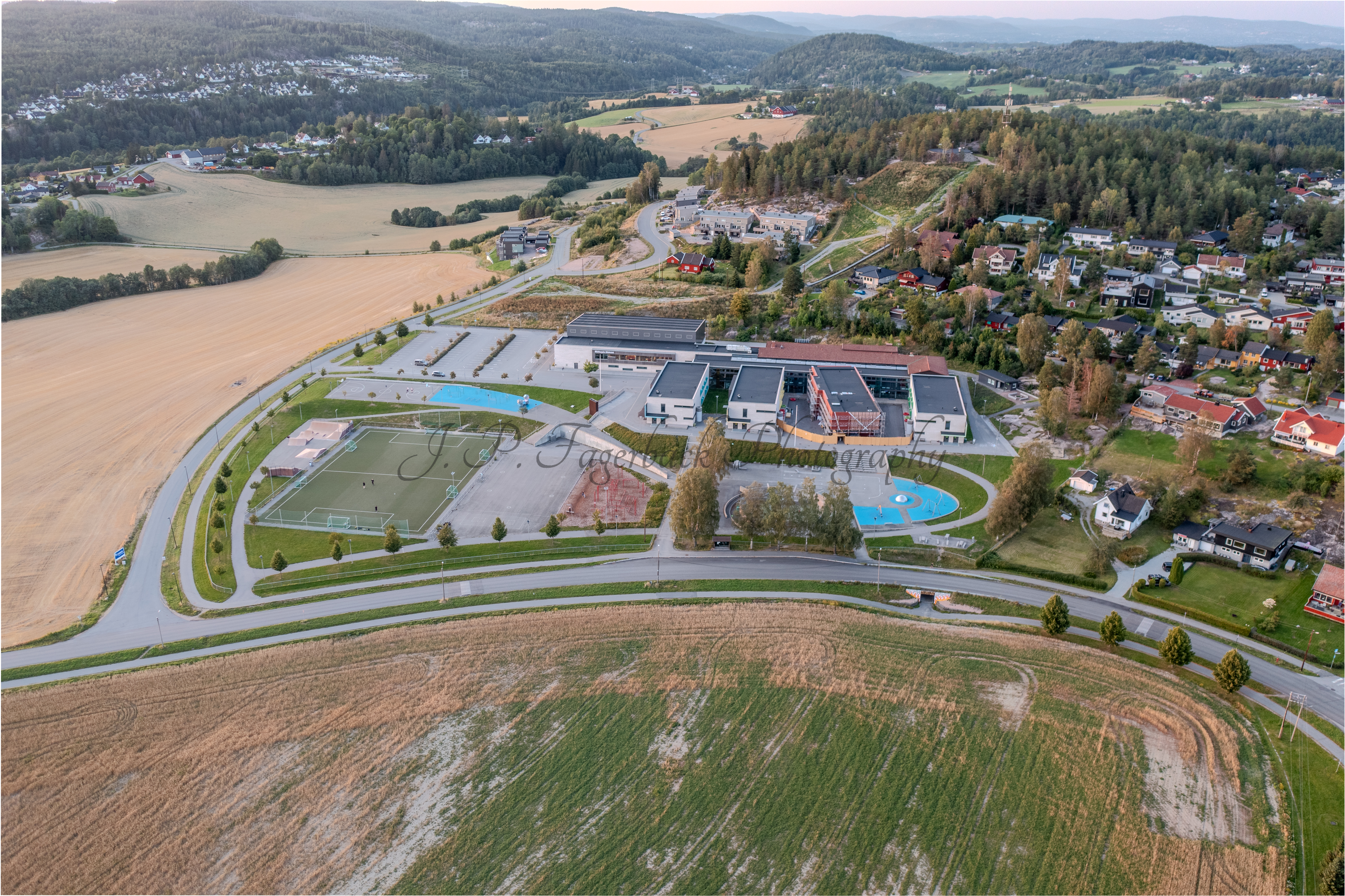 school with playgrounds with fiields and other buildings around
