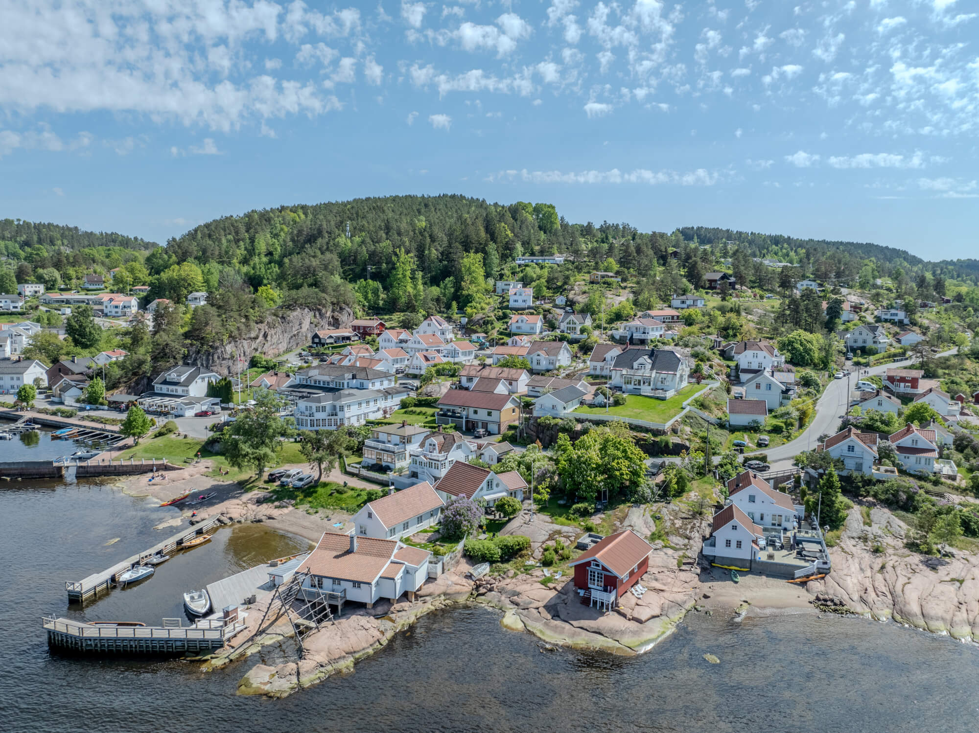 Buildings seen from a body of water with a blue sky