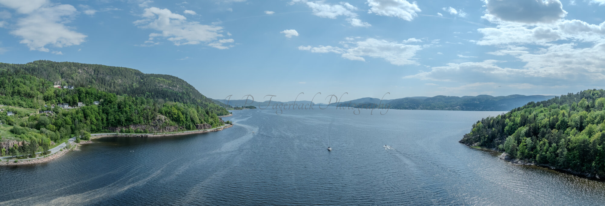 Buildings seen from a body of water with a blue sky
