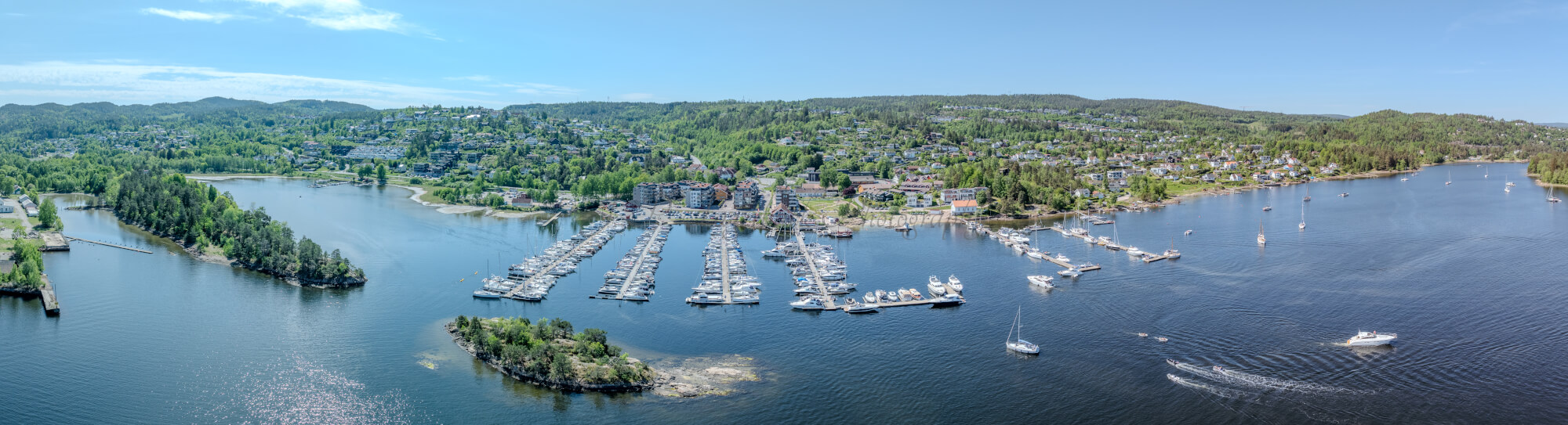 Buildings seen from a body of water with a blue sky