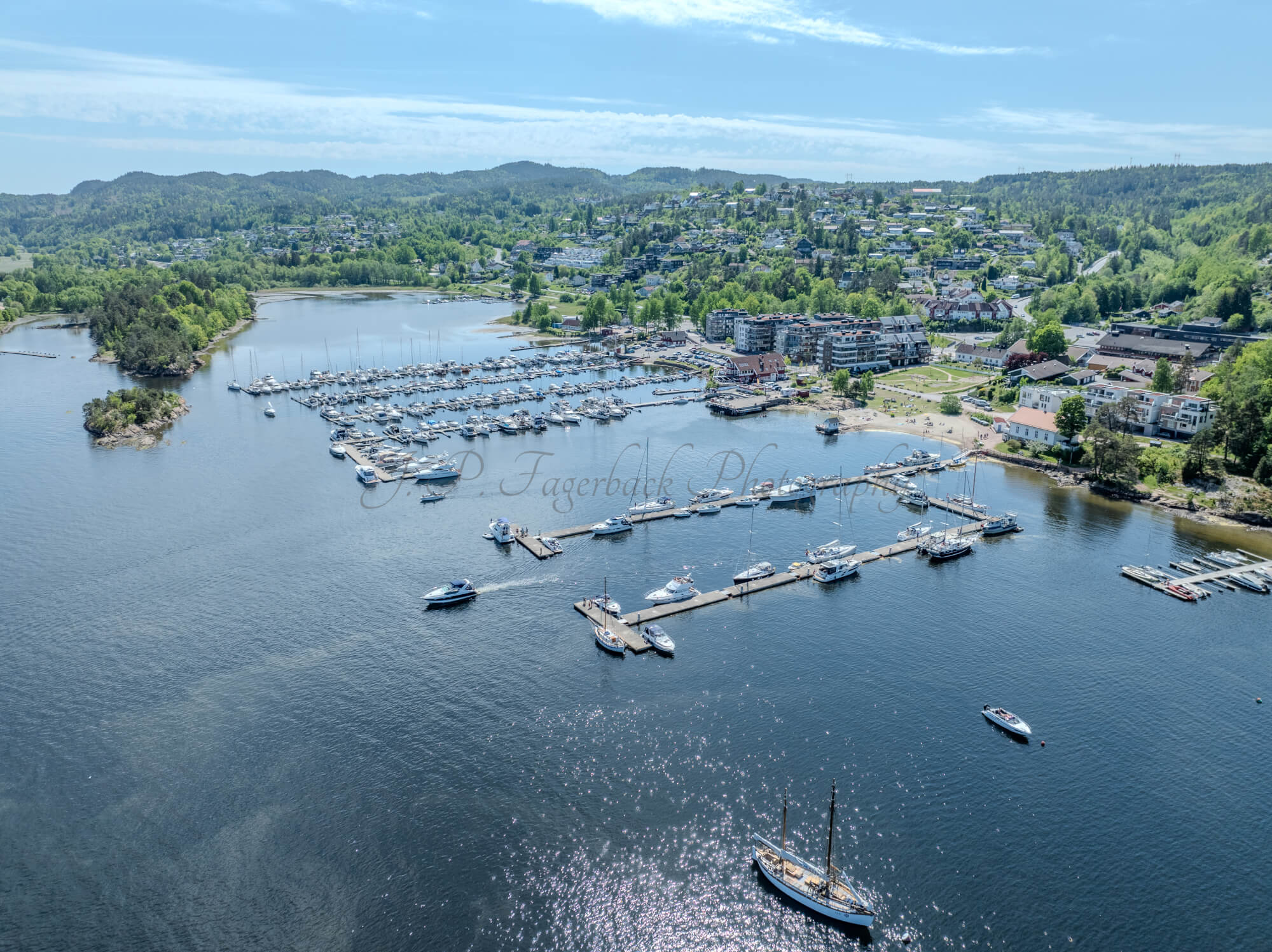 Buildings seen from a body of water with a blue sky