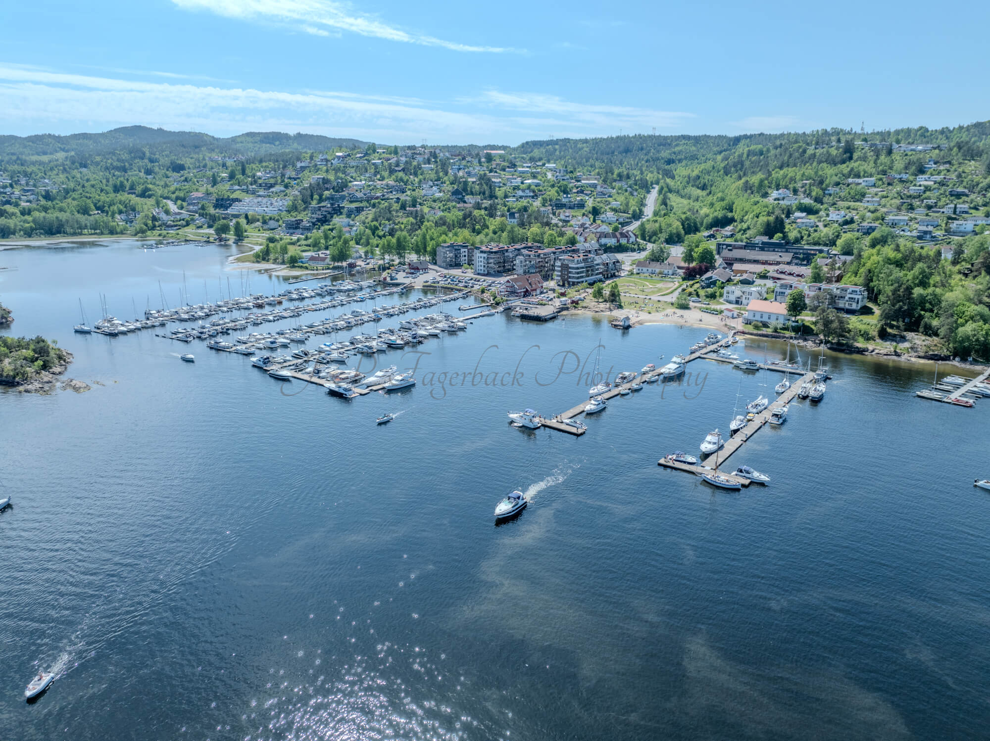 Buildings seen from a body of water with a blue sky