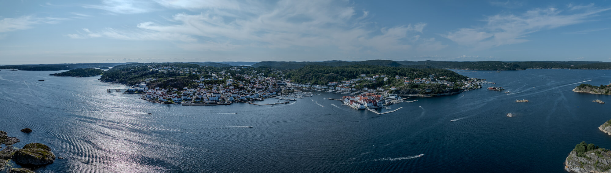 A panorama view of a town with small white houses along a shoreline