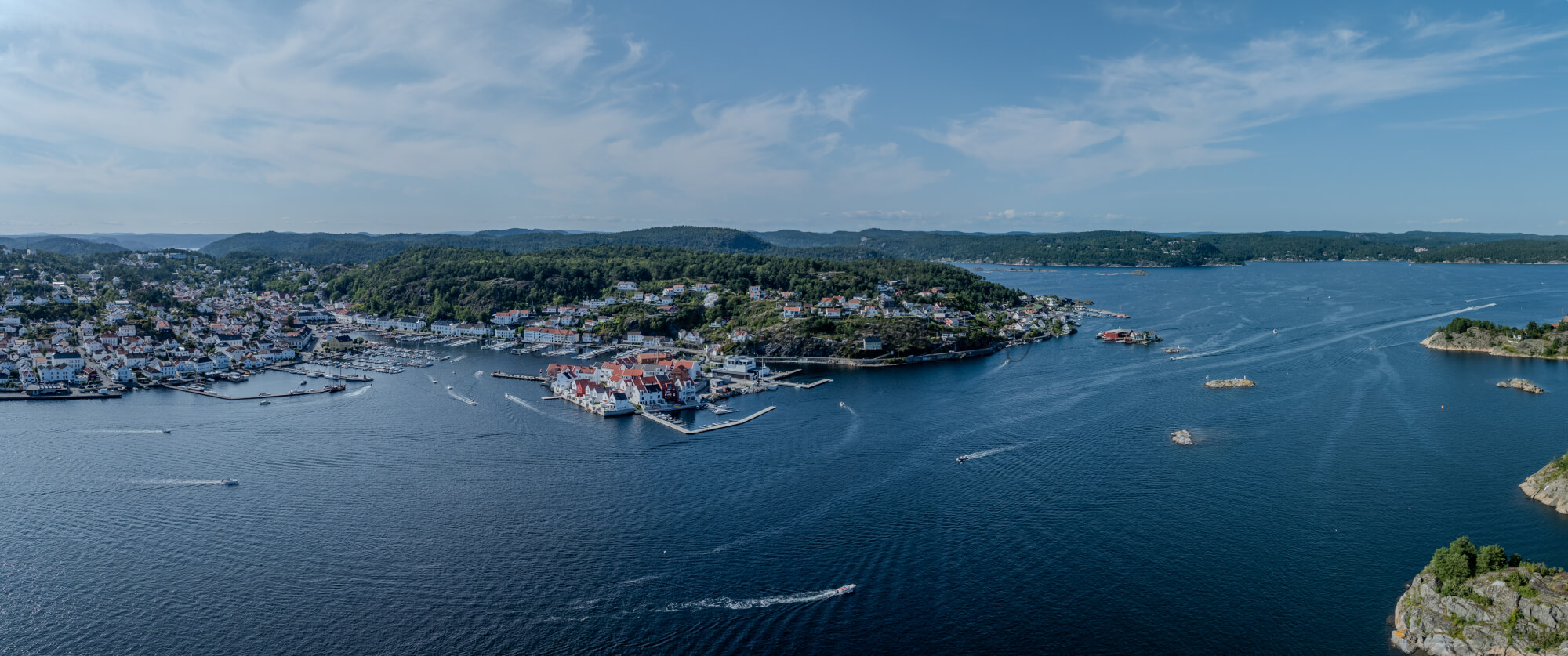 A panorama view of a town with small white houses along a shoreline