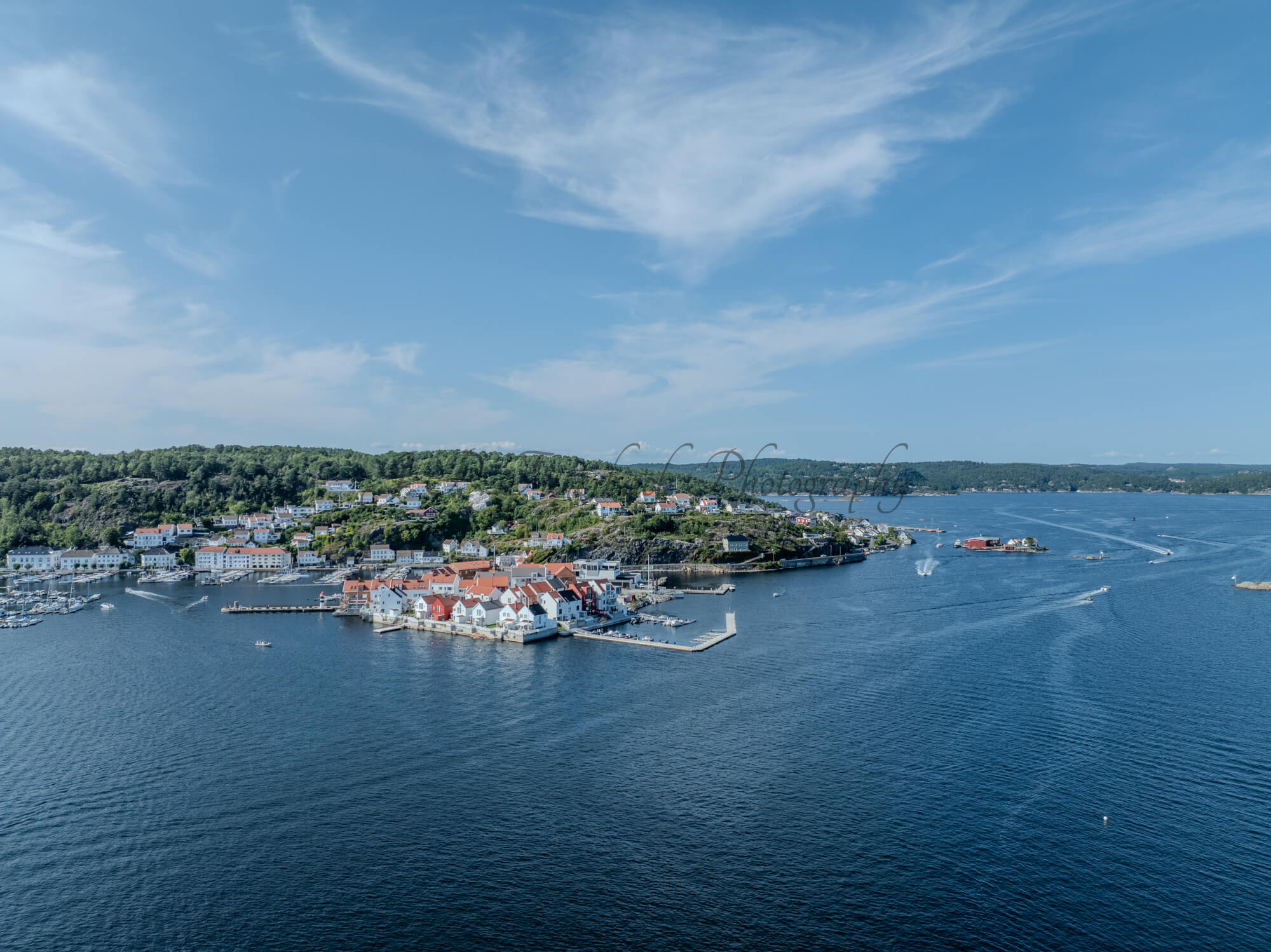 A town with small white houses along a shoreline