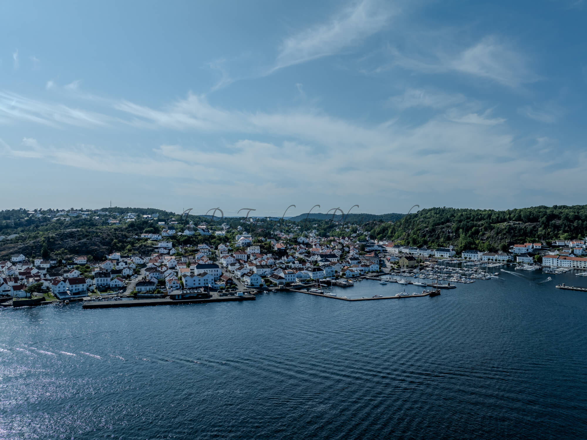 A town with small white houses along a shoreline