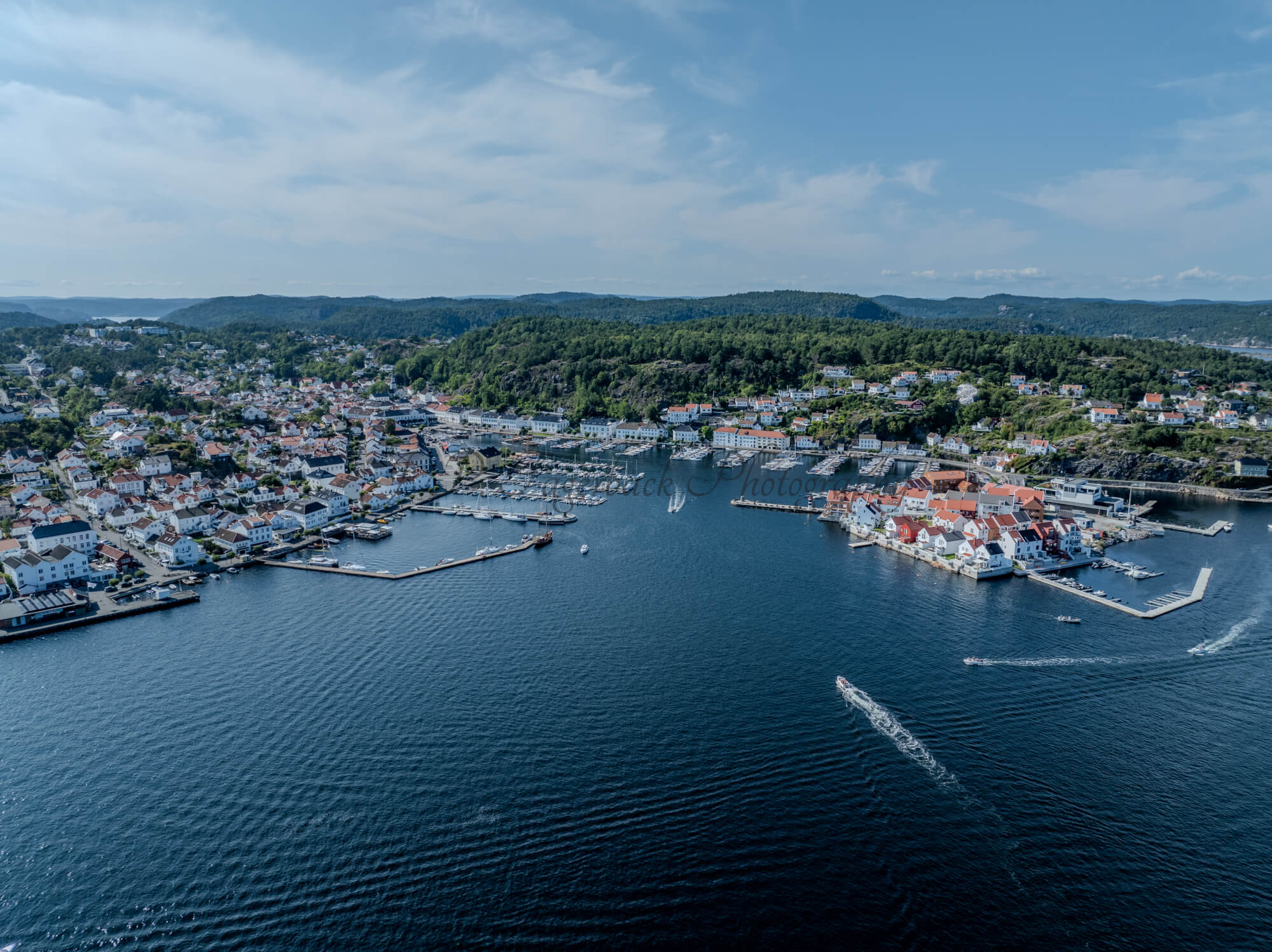 A town with small white houses along a shoreline