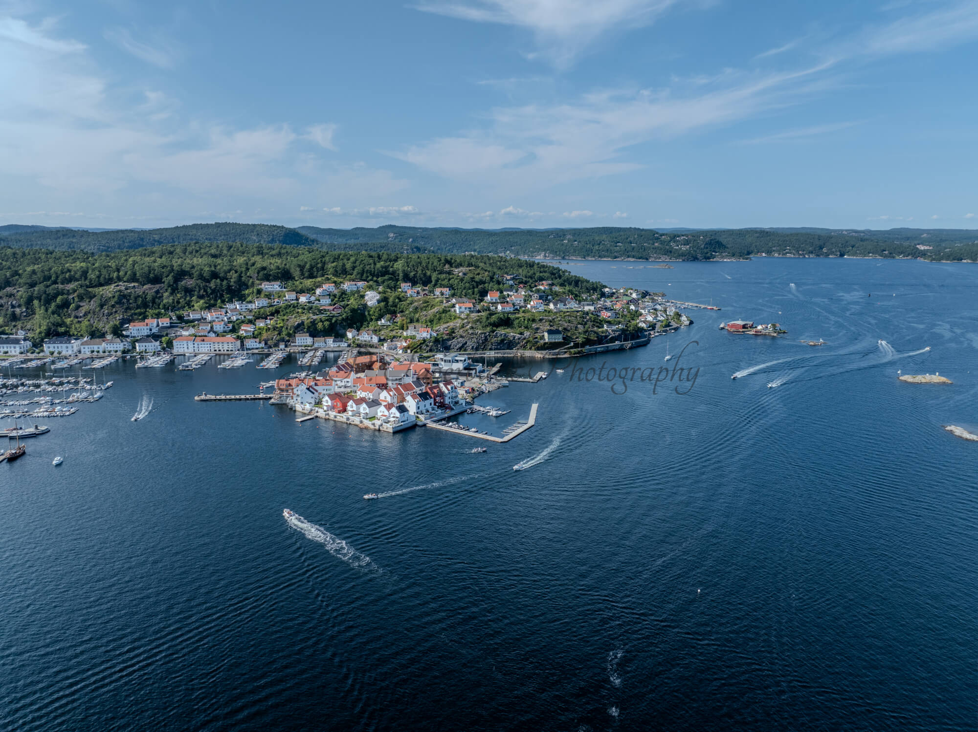 A town with small white houses along a shoreline